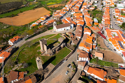 Scenic aerial view of small Portuguese township of Mogadouro with brownish tiled roofs 