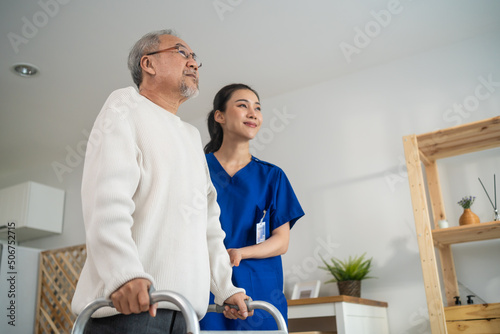 Asian senior elderly man patient doing physical therapy with caregiver