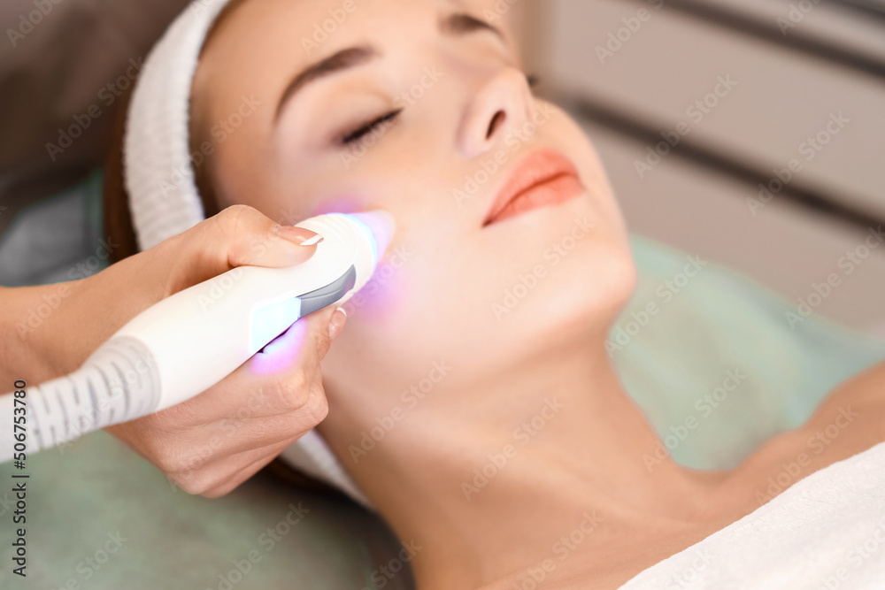 Pretty young woman visiting cosmetologist in beauty salon