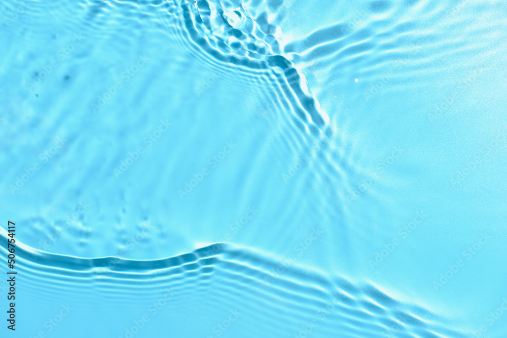 Texture of water with ripples on blue background, closeup Texture of water with ripples on blue background, closeup