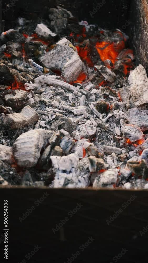 Hot red coal smolders in the barbecue close-up. Cooking food on charcoal Hot red coal smolders in the barbecue close-up. Cooking food on charcoal