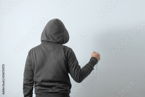 Photography rear view of man holding knife