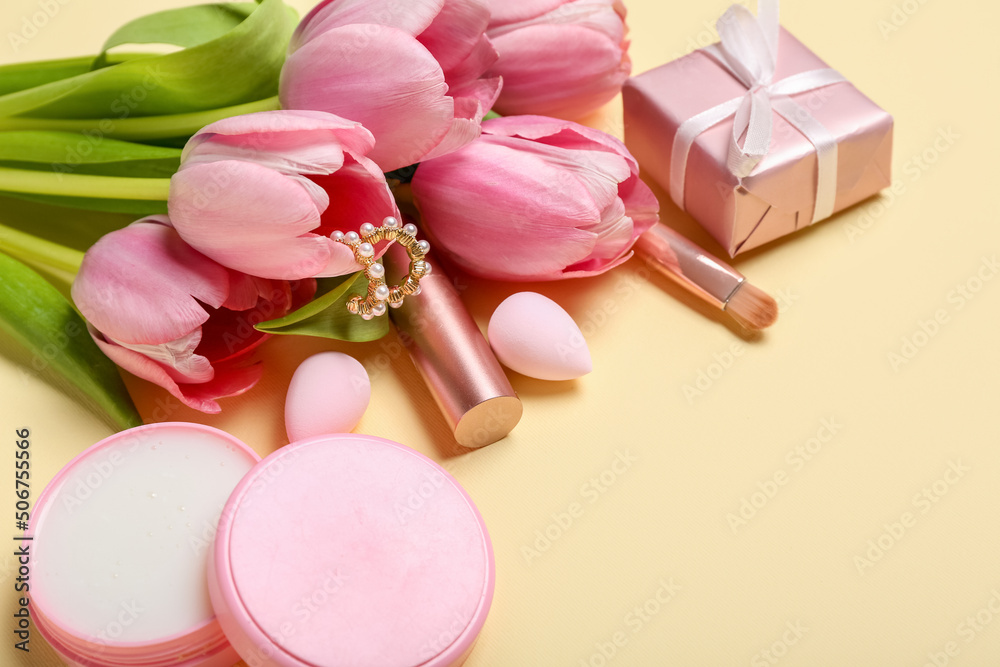 Bouquet of pink tulips, gift box and female accessories on yellow background Bouquet of pink tulips, gift box and female accessories on yellow background