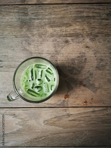 A glass of green tea on wooden table