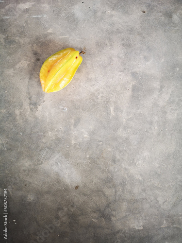 A yellow carambola on a background 2
