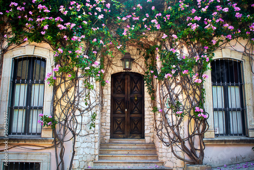 house with flowers door of wood and two windows in san miguel de allende guanajuato  photo