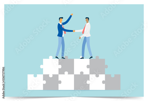 Businessmen shaking hands on a puzzle