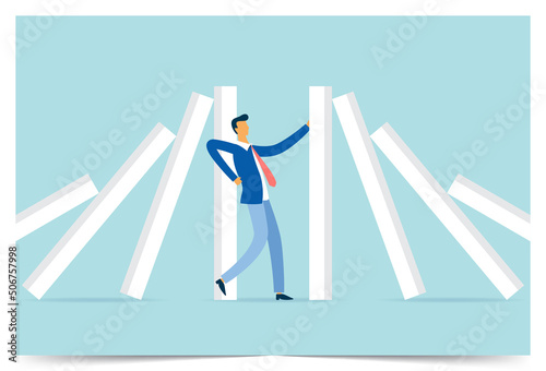Businessman stopping domino effect