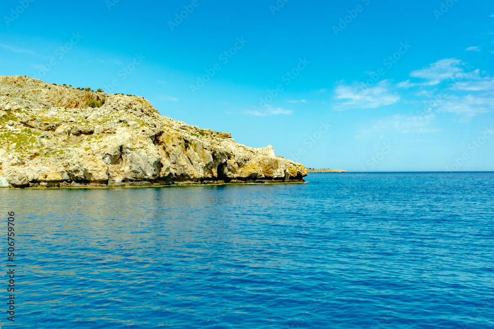 View of a bay with turquoise water in the Meditteranean island of Rhodes in Greece.