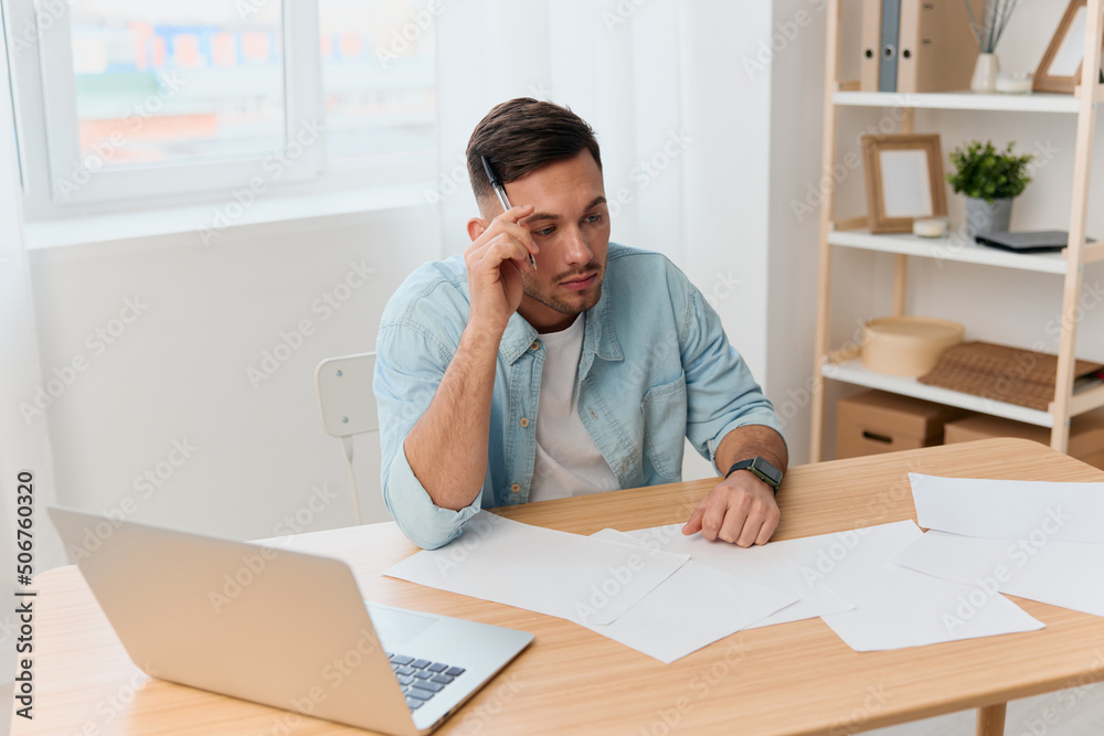 Naklejka premium Pensive serious thoughtful good-looking young businessman looks aside can not make difficult project decision in office. Copy space for ad. Remote Job, Technology And Career Profession Concept