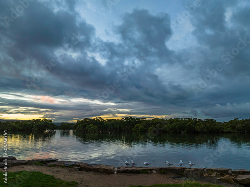 Fototapeta Naklejka Na Ścianę i Meble -  Rainy day sunset with clouds at the waterfront