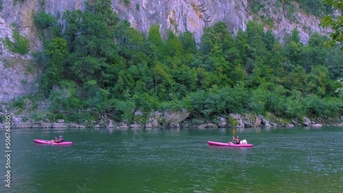 couple on the beach by the river in the Ardeche France Pont d Arc, Ardeche France,view of Narural arch in Vallon Pont D'arc in Ardeche canyon in France Europe photo