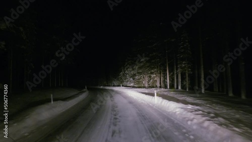 Bus Driver POV on snowy dark road turning spooky forest in Finland (Levi) photo