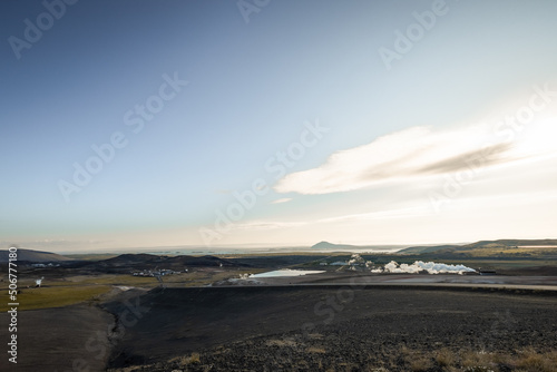 View of thermoelectric geothermal power and heating plant close to Krafla  Iceland with visible pipes  scenery  lake  tower  cooling tower and other stuff.