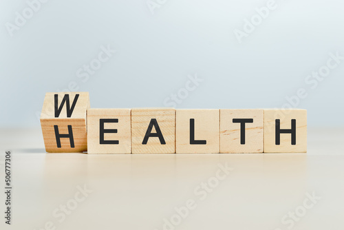 Fototapeta Naklejka Na Ścianę i Meble -  wealth and health concept, word wealth to health on wooden cube blocks. growth investment future value success.