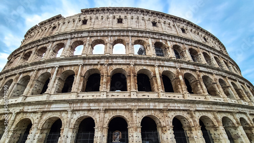 Panoramic view on exterior facade of famous Colosseum (Coloseo) of city of Rome, Lazio, Italy, Europe. UNESCO World Heritage Site. Flavian Amphitheater of ancient Roman Empire. Concept tourism