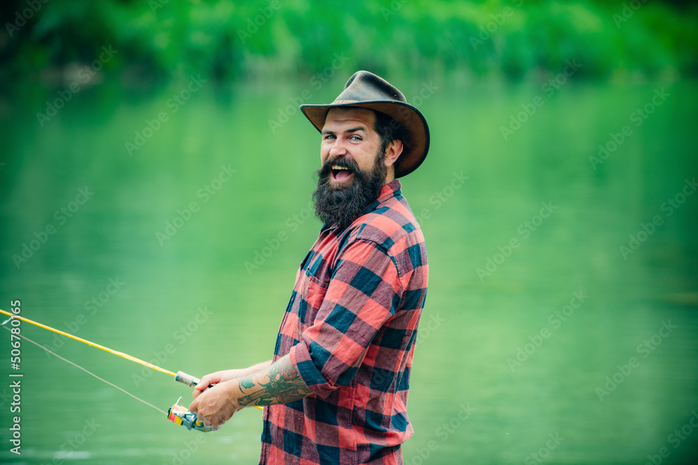 Fisherman fishing on a rever. Relaxed fisher man with a fishing rod on a summer day. Fisherman fishing on a rever. Relaxed fisher man with a fishing rod on a summer day.