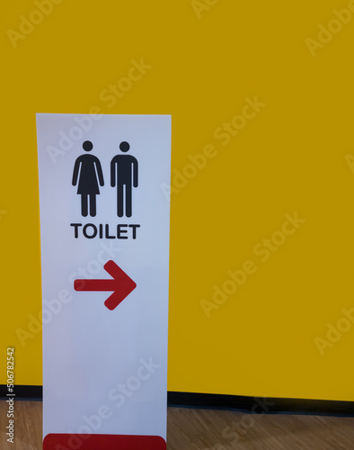 Men and women toilet or WC signs for restroom stand on the floor.