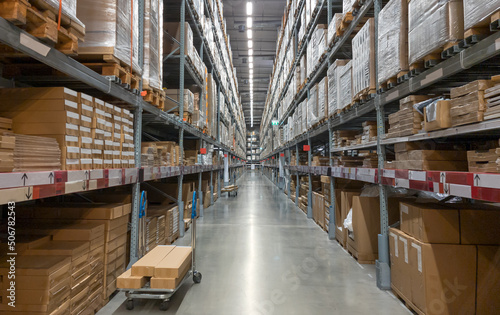 Distribution warehouse interior. Shelve with boxes in modern factory warehouse.