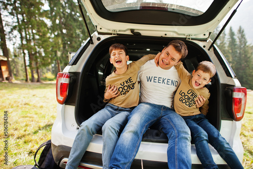 Family at vehicle interior. Father with his sons. Children in trunk. Traveling by car in the mountains, atmosphere concept. © AS Photo Family