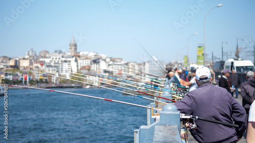 Fototapeta Naklejka Na Ścianę i Meble -  People resting and local fishermen catching fish in the Black Sea