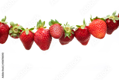 Red ripe strawberries hanging on isolated on white background