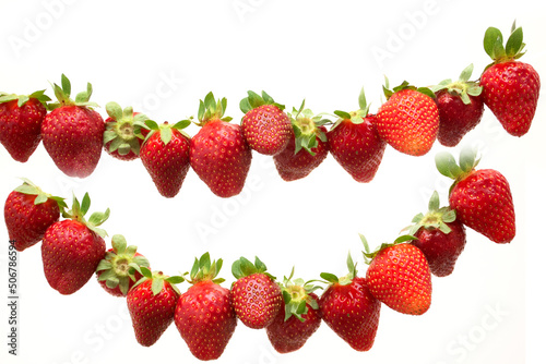 Set of differnet red ripe strawberries hanging on isolated on white background