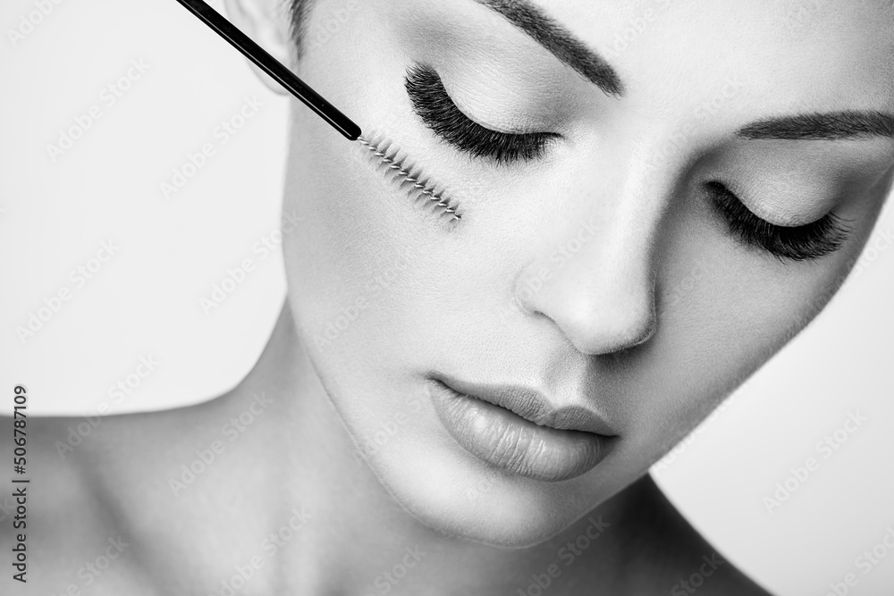 Beautiful Woman with Extreme Long False Eyelashes. Eyelash Extensions. Makeup, Cosmetics. Beauty, Skincare. Black and White photo