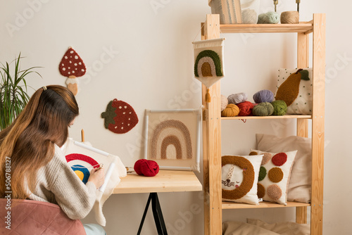 Fényképezés Female embroidering handmade picture rainbow on canvas