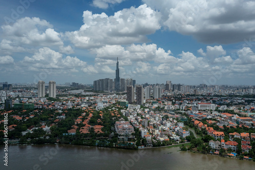Modern City aerial view on sunny day with waterfront houses and high rise buildings. Location is on the Saigon River, Ho Chi Minh City, Vietnam