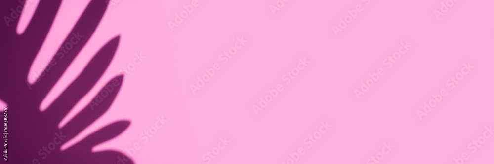 Fototapeta premium Trending concept in natural materials with palm leaves shadow on pink background. Presentation with daylight. Natural blurred shade. Summer sunlight from herb. Abstract beautiful backdrop for text or