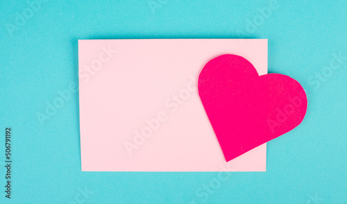 Pink envelope with a heart, empty copy space, blue background, valintines day greeting card, romantic mail, love letter photo