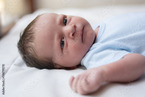one week old cute newborn infant baby boy expressions tiny feet details 