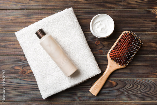 cosmetic for hair care, cream and towel on a colored background top view. flat lay