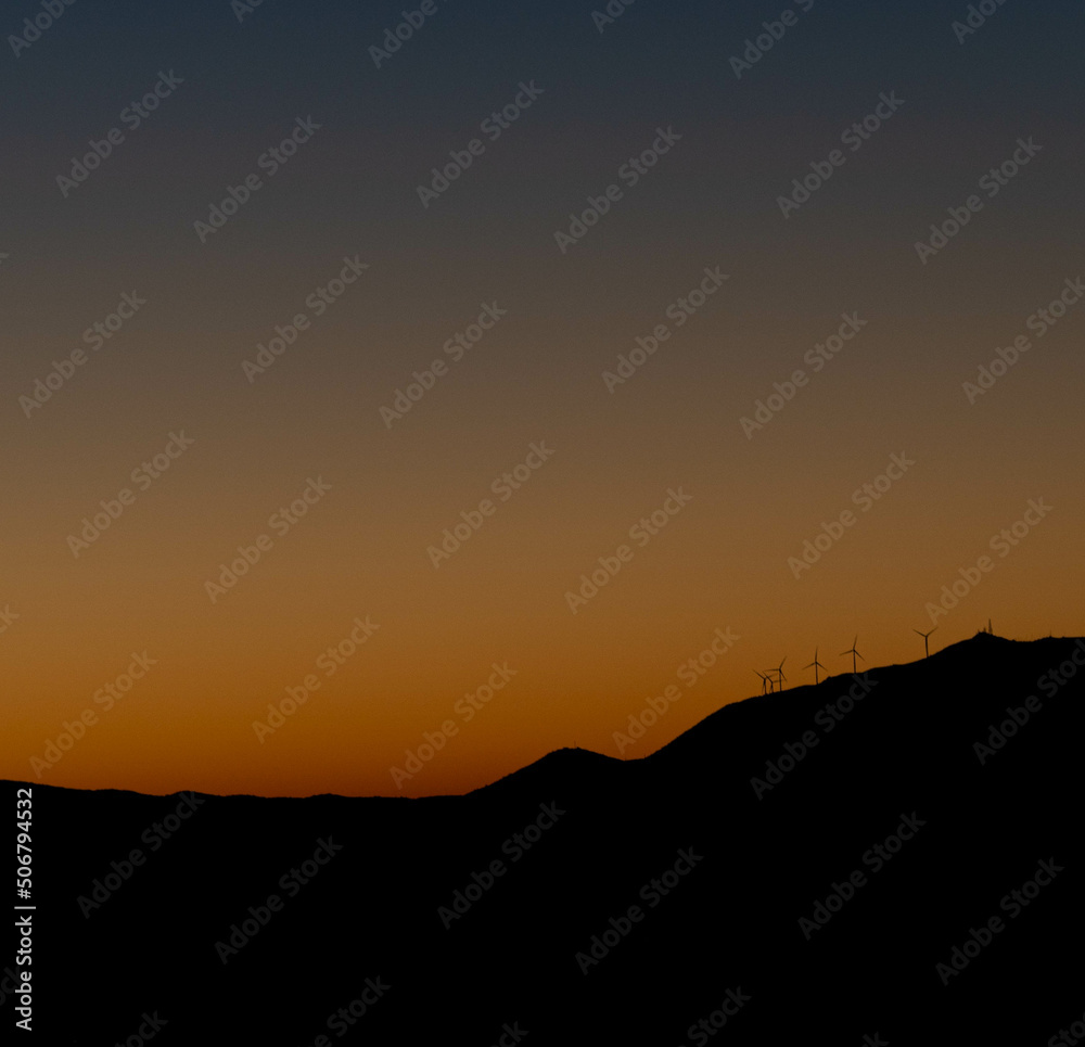 Mountain top wind turbines in sunrise in Greece Mountain top wind turbines in sunrise in Greece
