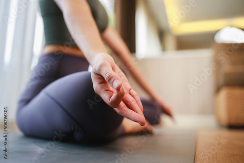 Yoga  Lotus pose close up of hand woman while sitting on the yoga mat in the living room at home