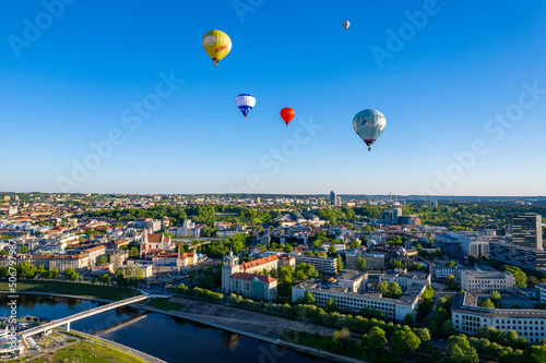 Aerial spring evening view of rising hot air balloons over the city of Vilnius, Lithuania