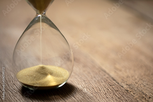 hourglass (sand clock) on an old wooden table, Hourglass as time passing concept for business deadline, elapsed time concept, copy space