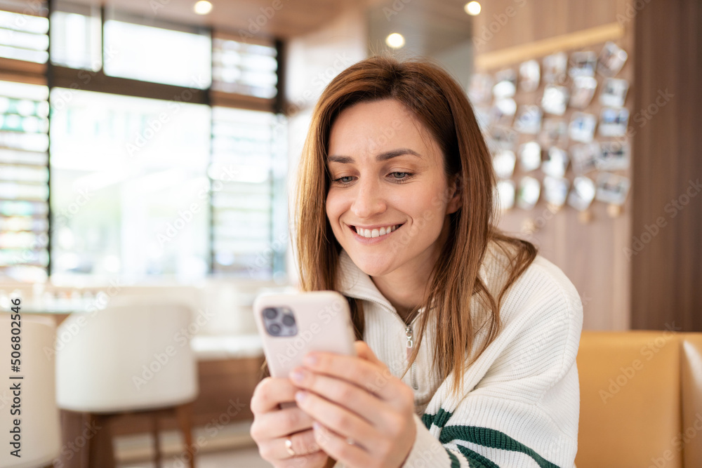 hipster modern woman using mobile phone in a cafe. Digital lifestyle. Female at coffee shop having a video chat on smart phone. hipster modern woman using mobile phone in a cafe. Digital lifestyle. Female at coffee shop having a video chat on smart phone.