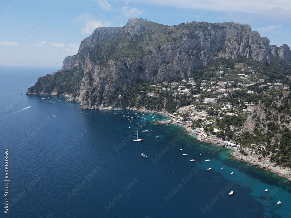 Aerial view of Capri, an island on the south side of the Gulf of Naples in the Campania region of Italy. Drone view of Faraglioni di Capri. 