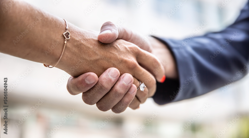 Obraz premium Detail of a professional handshake of a male and female hand