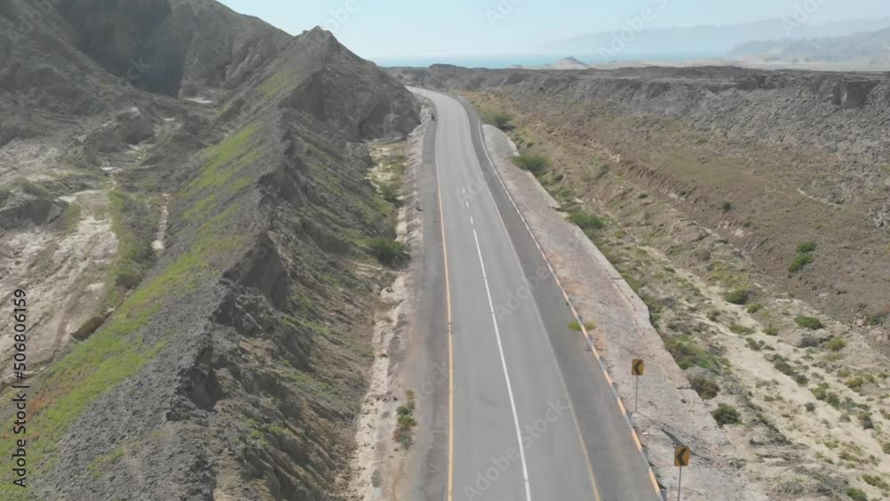 Aerial shot of beautiful empty Coastal Highway along Pakistan's Arabian Sea coast. The beauty of nature will blow your mind. Aerial shot of beautiful empty Coastal Highway along Pakistan's Arabian Sea coast. The beauty of nature will blow your mind.