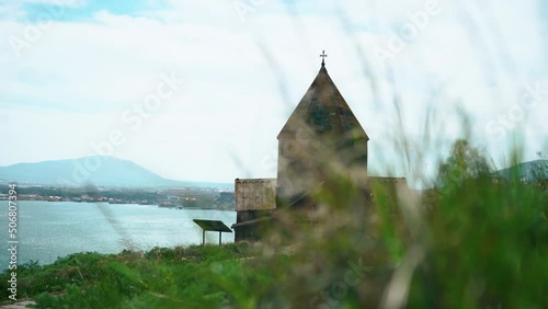 Sevanavank Monastery by Sevan Lake in Armenia and green grass . High quality 4k footage photo