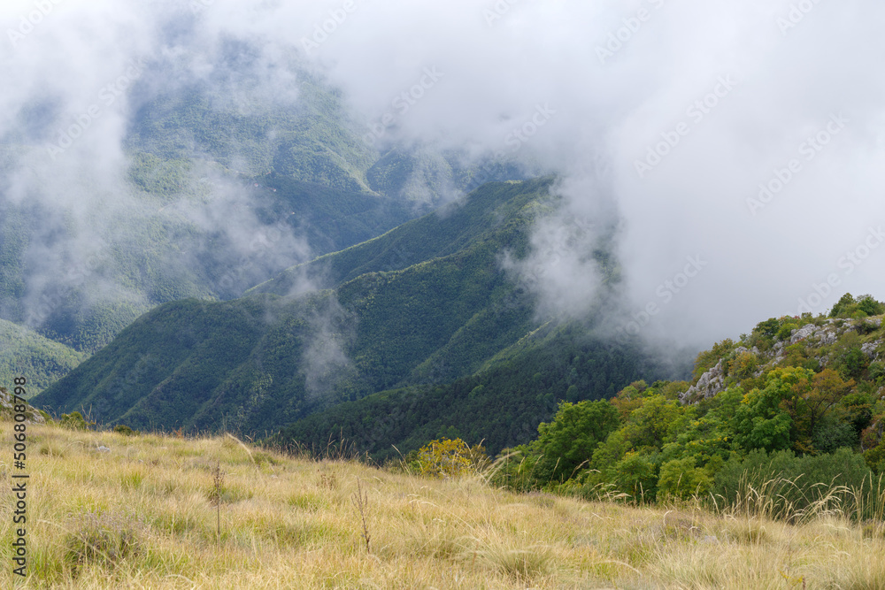 Fog revealing the mountain range in Ligurian Alps, Italy