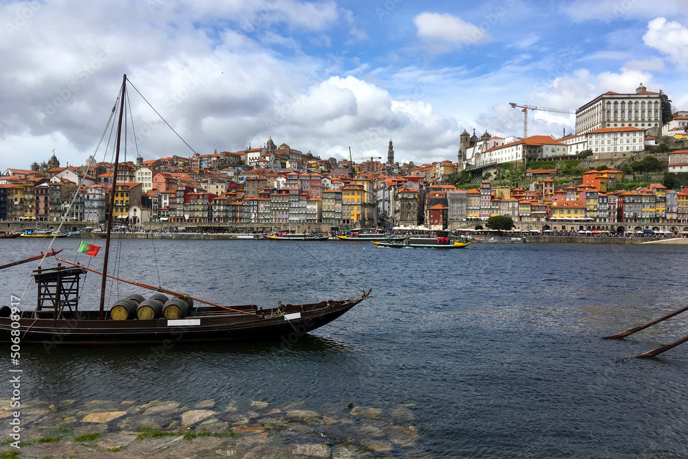 Porto traditional boat with barrels in the old harbour of Douro river