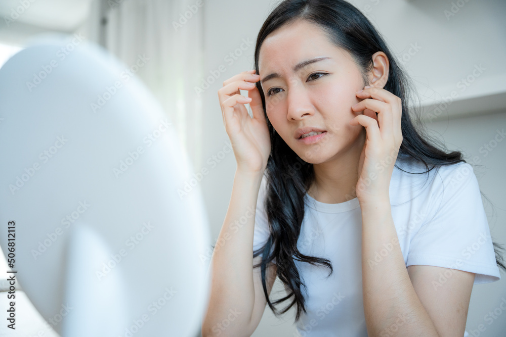 Young woman asian are worried about faces Dermatology and allergic to steroids in cosmetics. sensitive skin,red face from sunburn, acne,allergic to chemicals,rash on face. skin problems and beauty Young woman asian are worried about faces Dermatology and allergic to steroids in cosmetics. sensitive skin,red face from sunburn, acne,allergic to chemicals,rash on face. skin problems and beauty