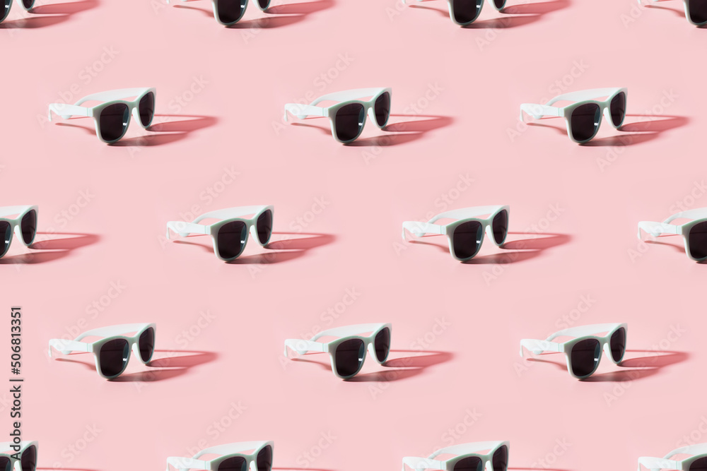 Seamles pattern of sun glasses with sunny shadow on pink background. Summer concept.