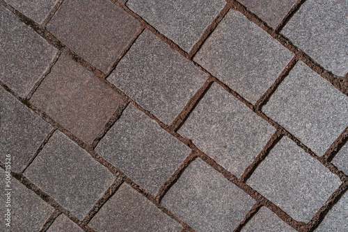 Pattern of ancient bricks and stones at old middle age pavement  as a background  closeup  details.