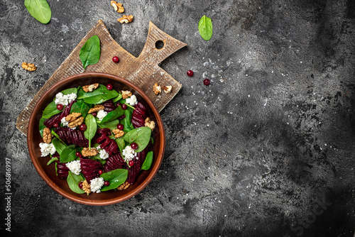 Healthy Beet Salad with fresh sweet baby spinach, cheese, nuts, cranberries. Clean eating, dieting, vegan food concept. Long banner format. top view
