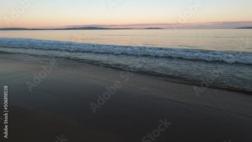 Wallpaper Mural soft pastel toned sunset over the Pacific Ocean at the beach in Tasmania with dog running towards the water Torontodigital.ca